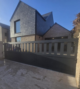 Modern bespoke aluminium driveway gate installed outside a UK home